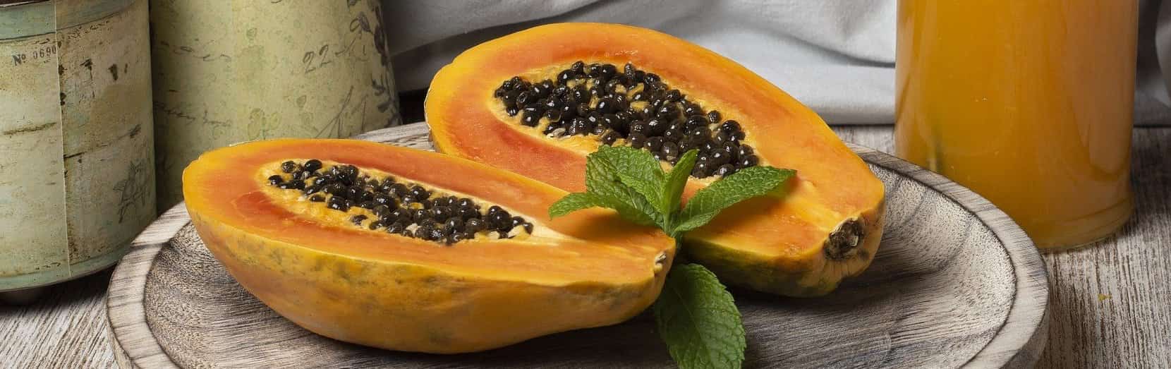 Papaya-Kerne - aufgeschnittene Papaya auf einem Brett